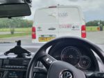 A driver's view of council van in front with 'it's not worth the risk' sticker on back of van