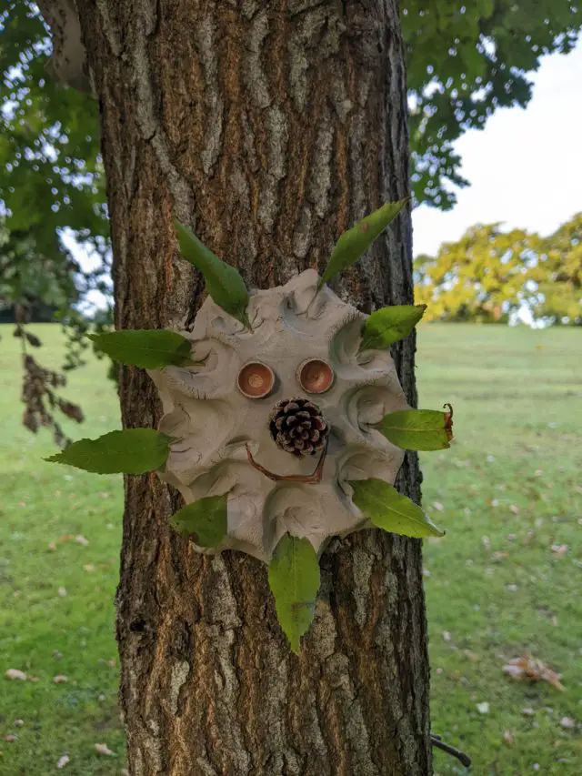 One of the clay sculptures on a tree