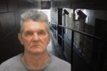 Mugshot of Graham Medway on top of photo of Jail corridor