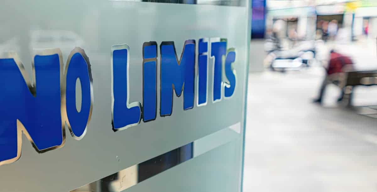 No Limits logo with blurry photo of people in the background