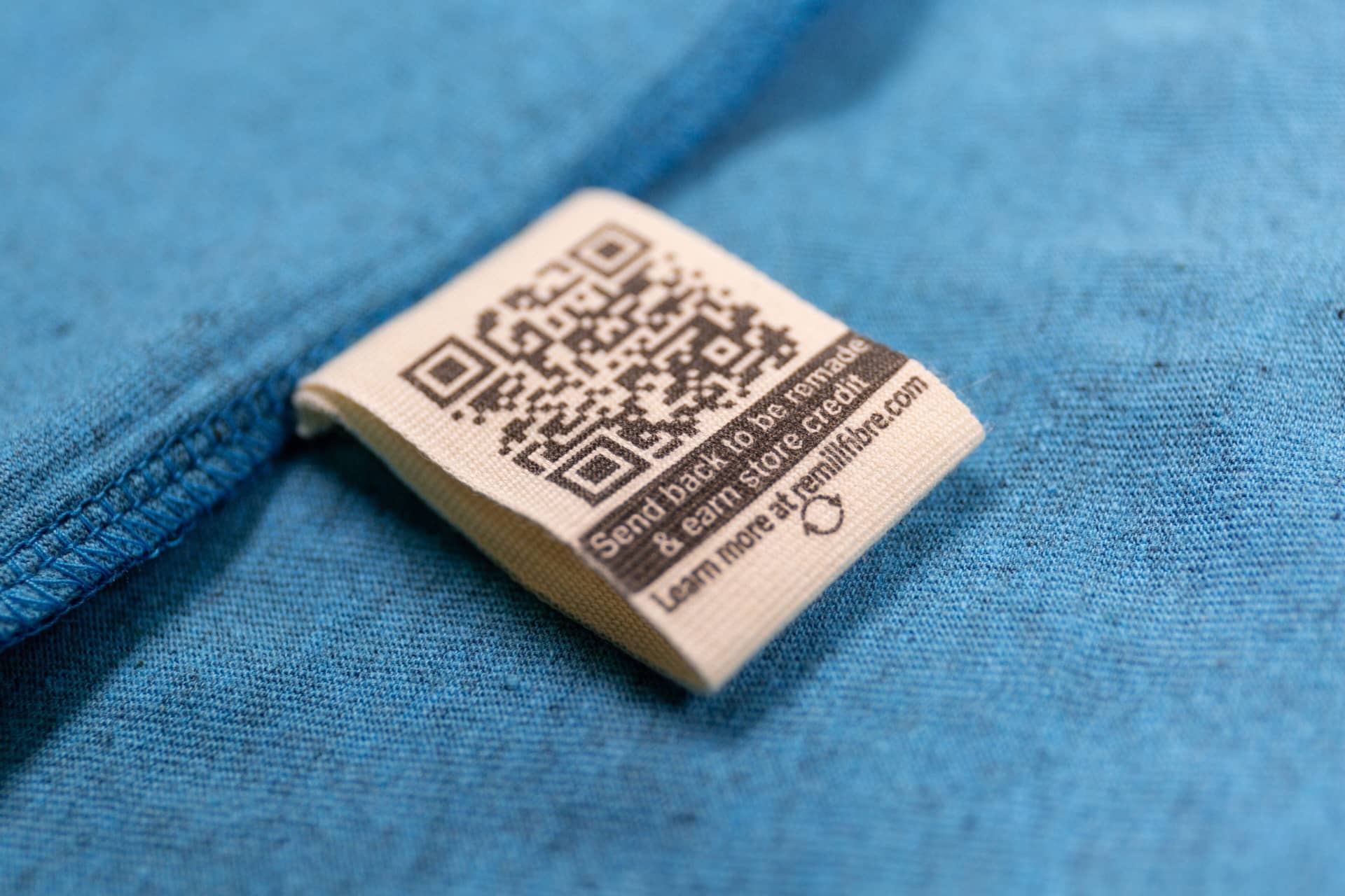 T-shirt label with instructions to send back for reuse - part of Teemill's Take Back Friday campaign