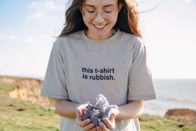 Woman wearing T-shirt that says 'This T-Shirt is rubbish' as part of Teemill's Take Back Friday Campaign