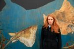 Artist Hannah Horn in front of Blue Reef mural © Sian Addison