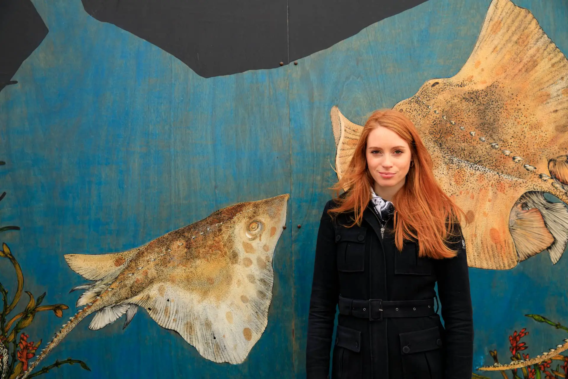 Artist Hannah Horn in front of Blue Reef mural © Sian Addison