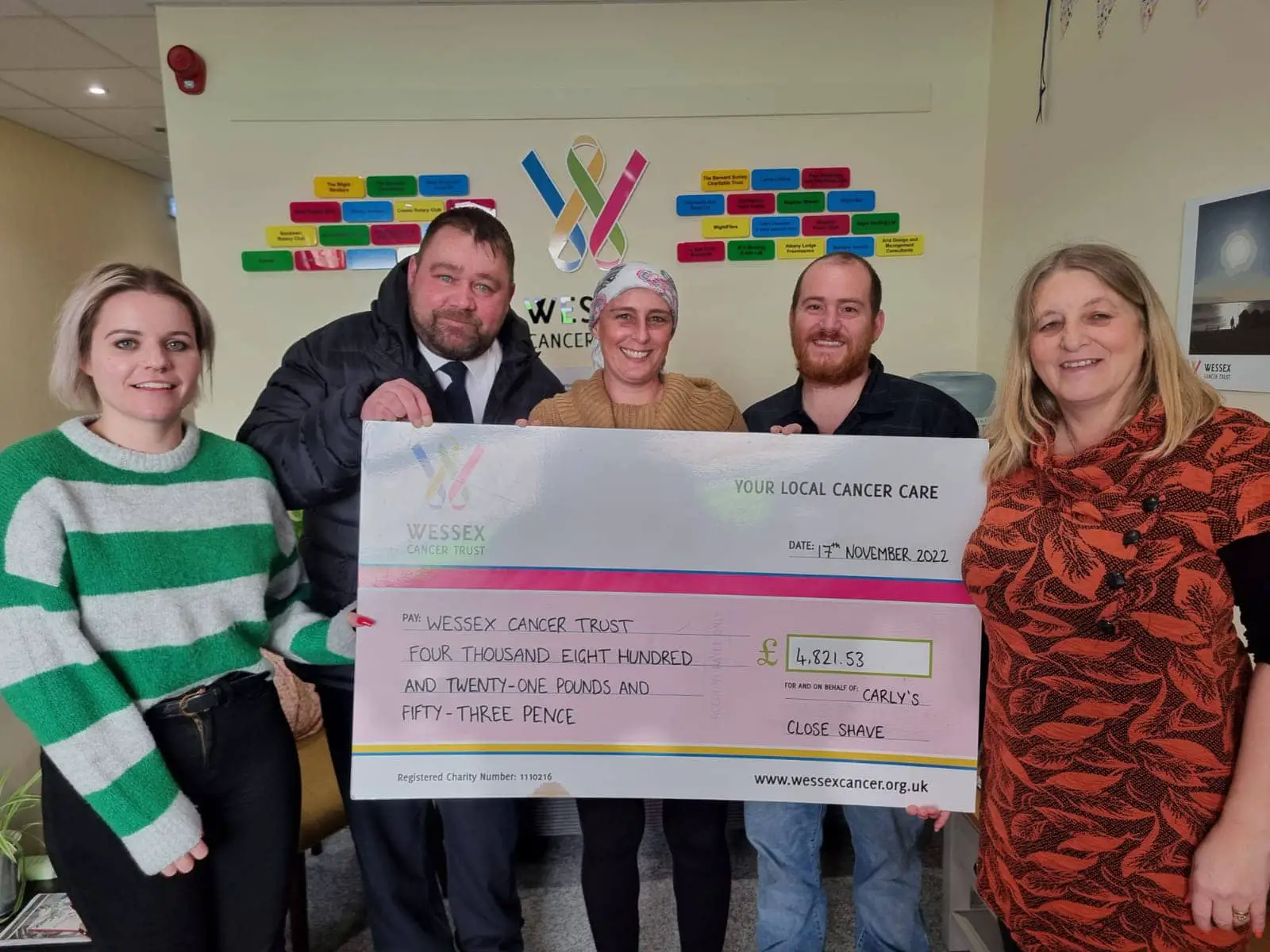 Image: From left to right in attached photo showing Carly coming into Wessex Cancer Trust Support Centre in Newport for cheque presentation; Laura Haytack (Regional Fundraising Manager for Wessex Cancer Trust), Danny Winter (Doorman for Slug and Lettuce), Carly Sanders, Simon Cant (Owner of The Castle Inn), Linda Huntley (Wessex Cancer Trust Volunteer)