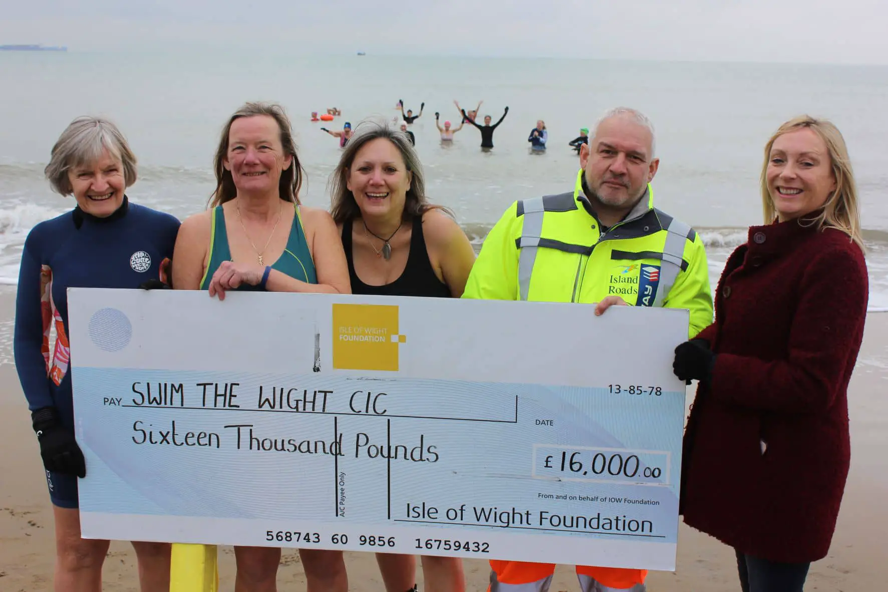 Swim the Wight group receiving their cheque