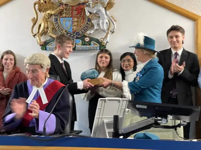 Students being presented trophy at Mock Trials event