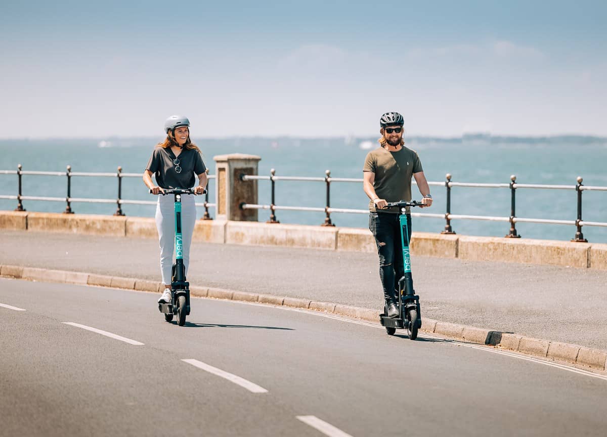 People riding beryl scooters in Cowes, Isle of Wight