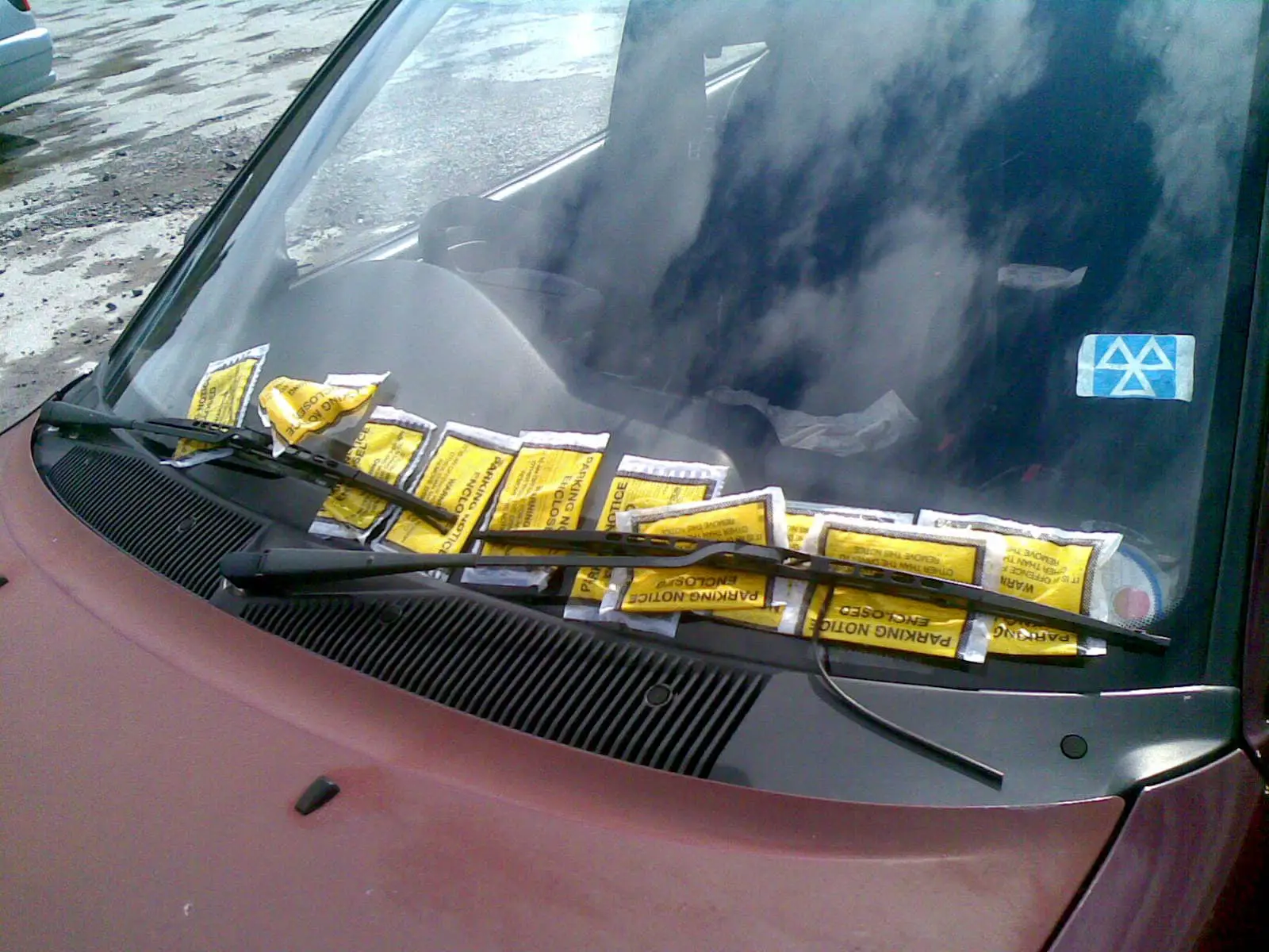 Car with loads of parking tickets on the windscreen