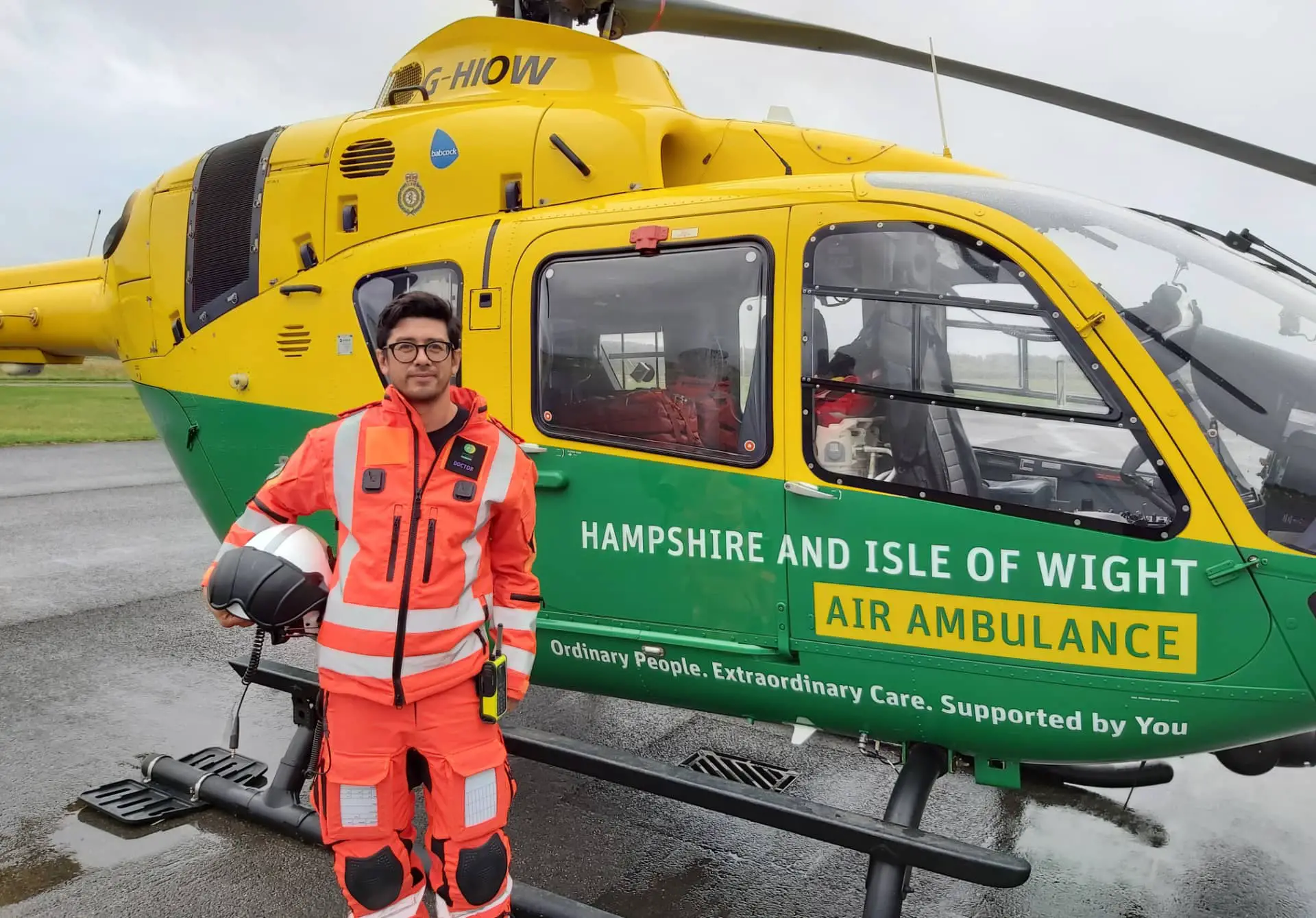 Dr Chris Beng next to the air ambulance helicopter