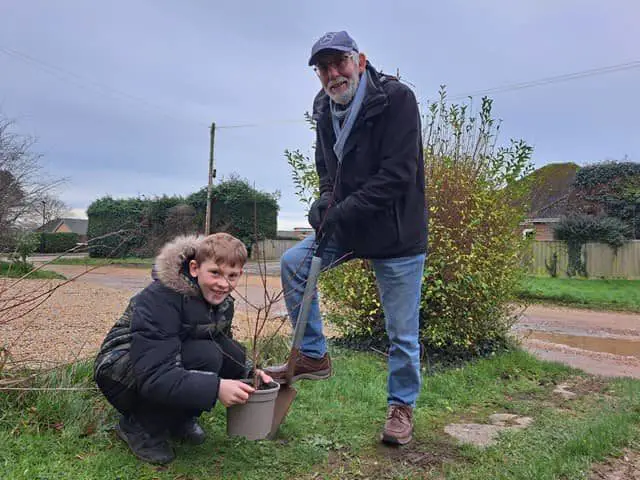  Elliott, aged ten, and his grandad Barry planting a tree