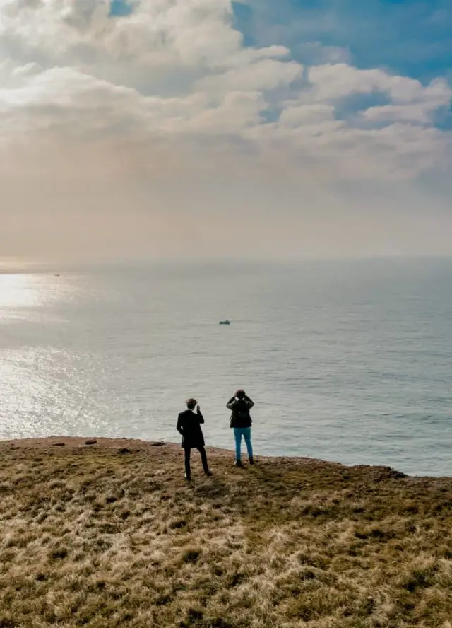Liam Patrick Harrison Samuel Bossman standing on cliff edge