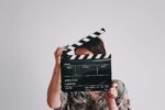 Woman holding a film clapperboard