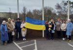 Ukrainian guests holding the flag at County Hall