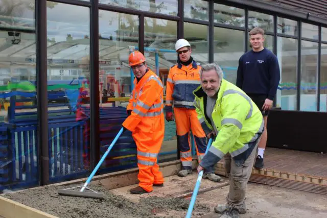 Cllr Lilley (orange PPE) with Mike Carter, Jono Hollman (WBM trainee plant manager) and Jacob Jenner (senior lifeguard).