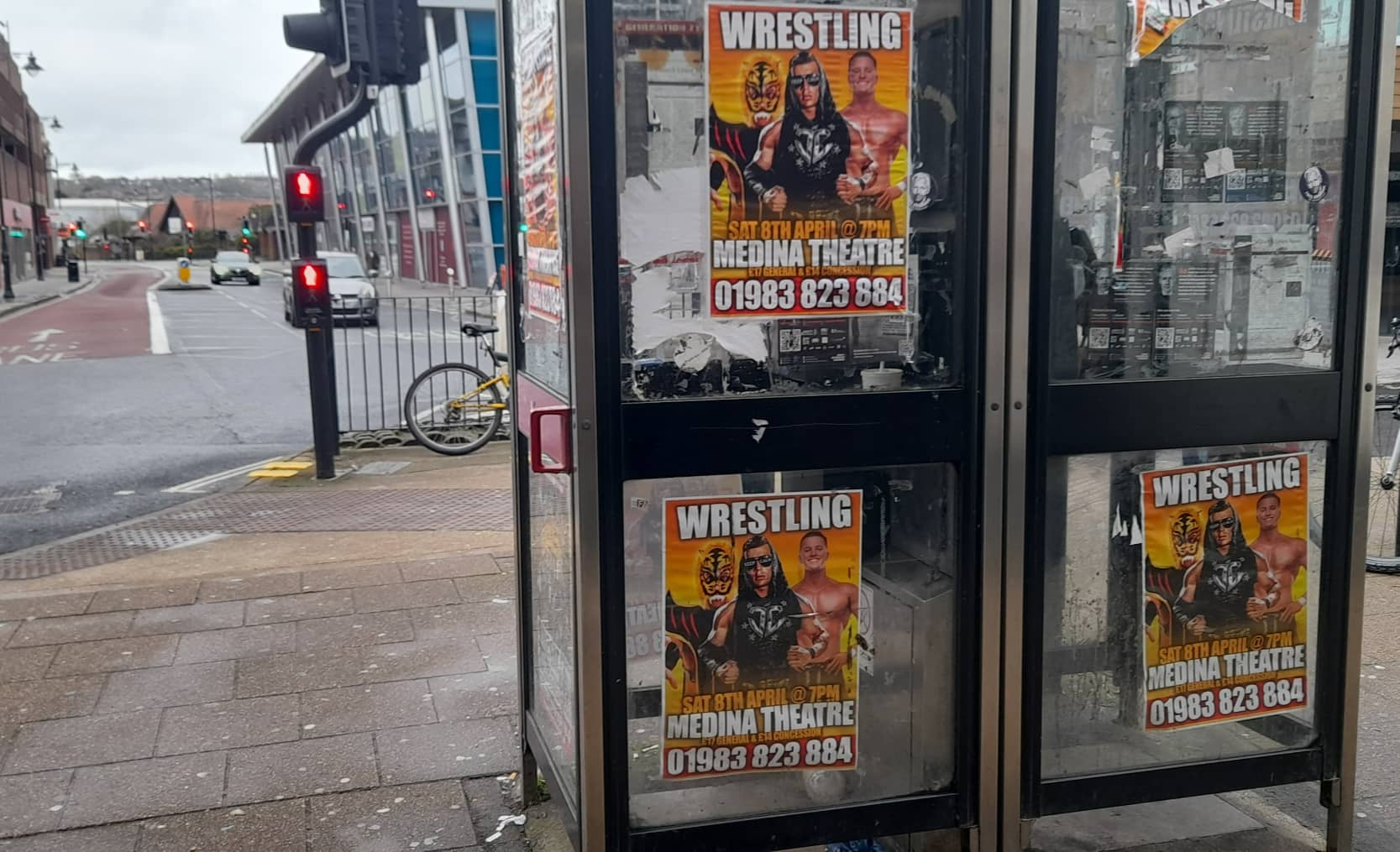 Wrestling posters on the phone boxes by Broc Silva