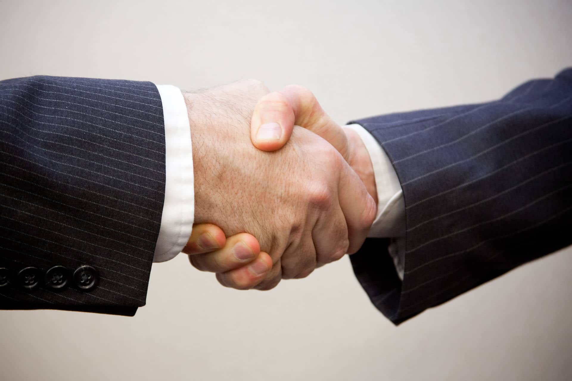 Two men in suit shaking hands
