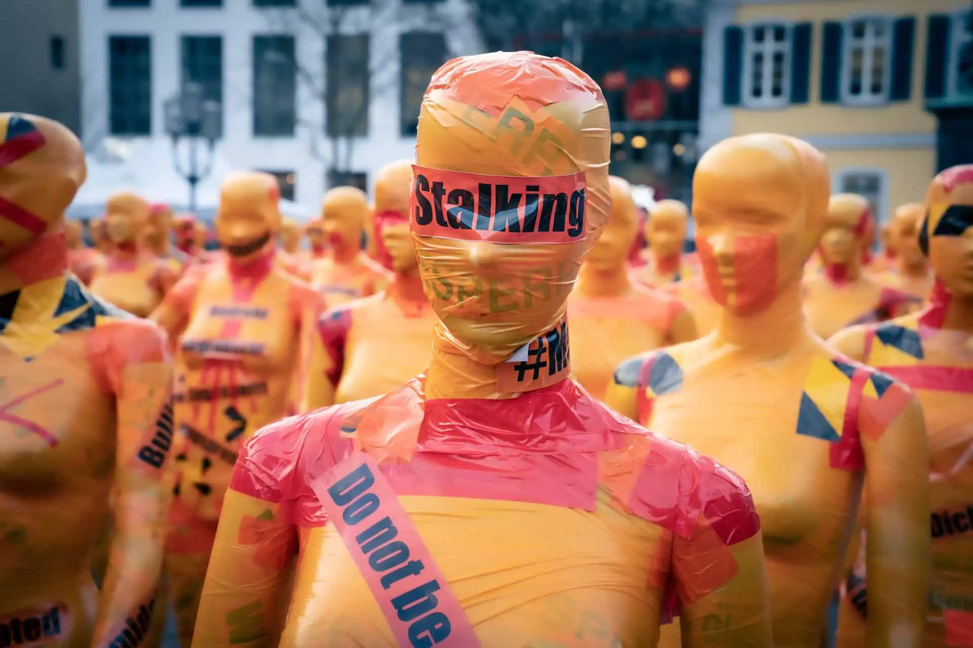 Mannequins covered in tape with stalking and do not touch written on it