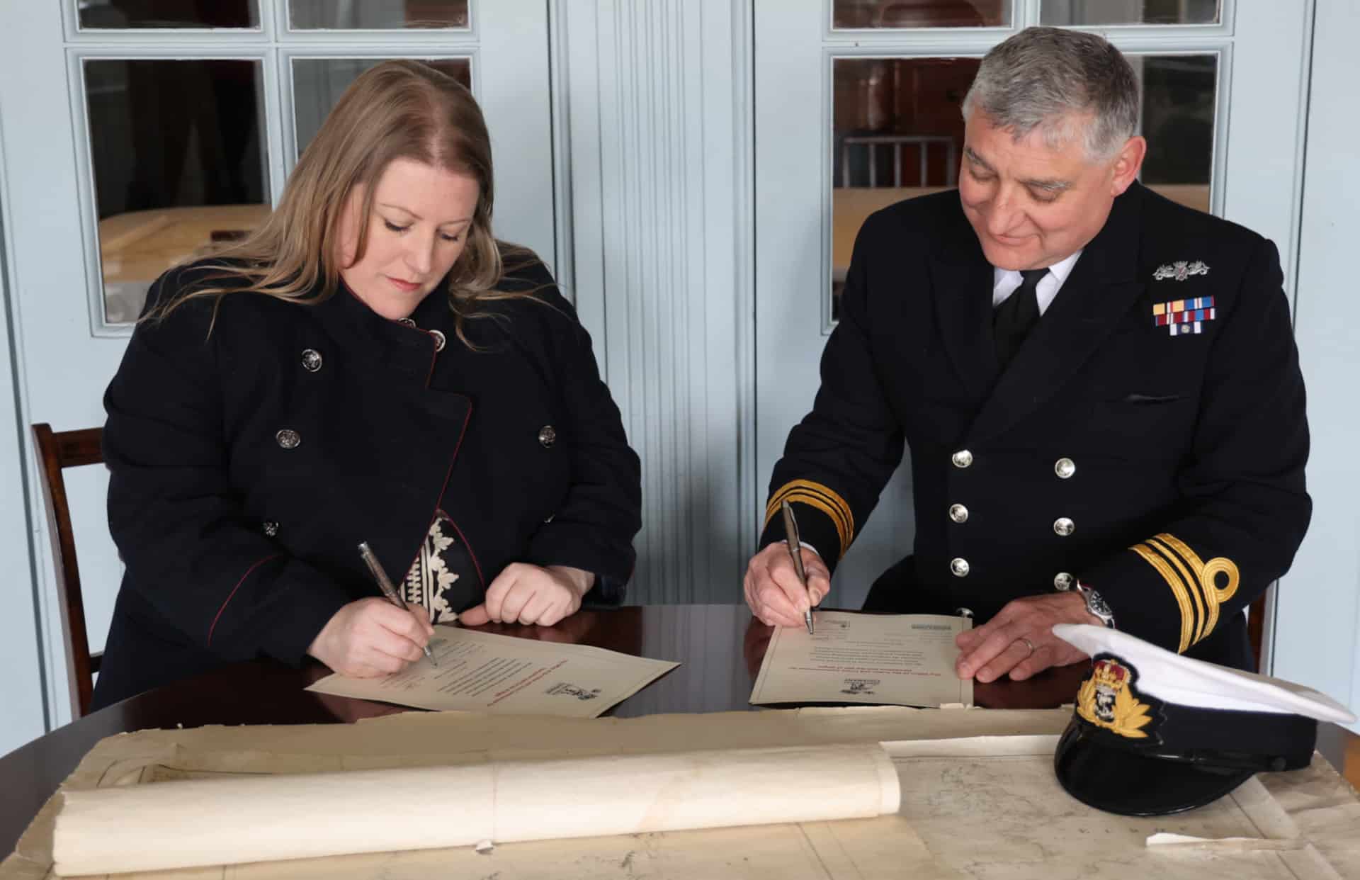 PCC Donna Jones and Lieutenant Commander BJ Smith, Commanding Officer of HMS Victory signing the covenant,