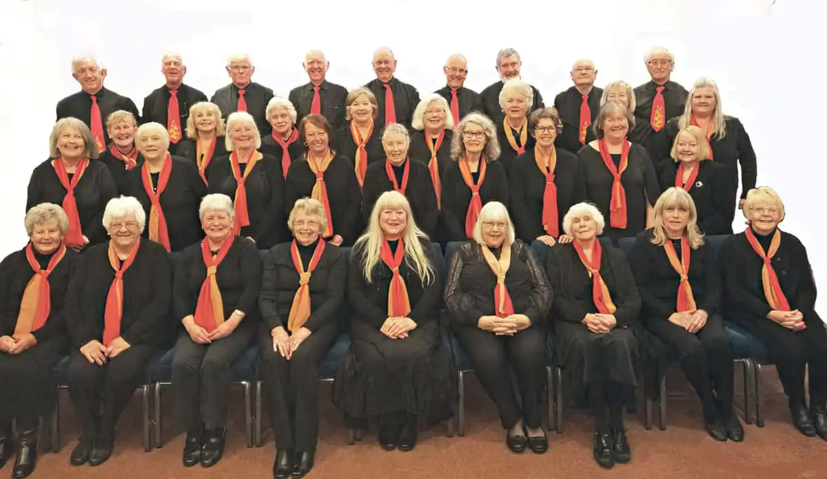 Members of phoenix choir sitting on chairs