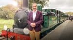 Michael Portillo standing in front of a steam train