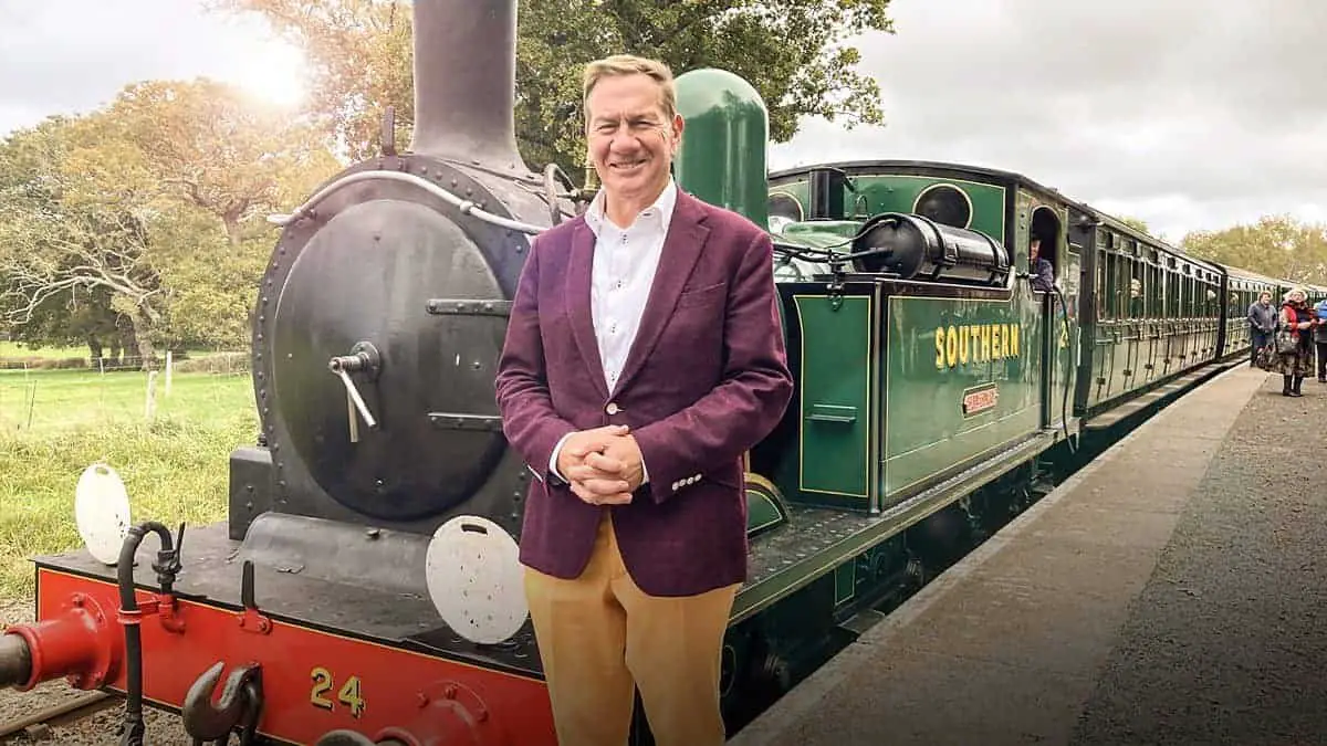 Michael Portillo standing in front of a steam train