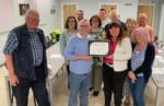 Chair Cllr Andrew Garratt giving the certificate to ‘Wombles’ Wendy Marshall, Jane Gibbs and Lin Hayward (front right) with NCCC Councillors