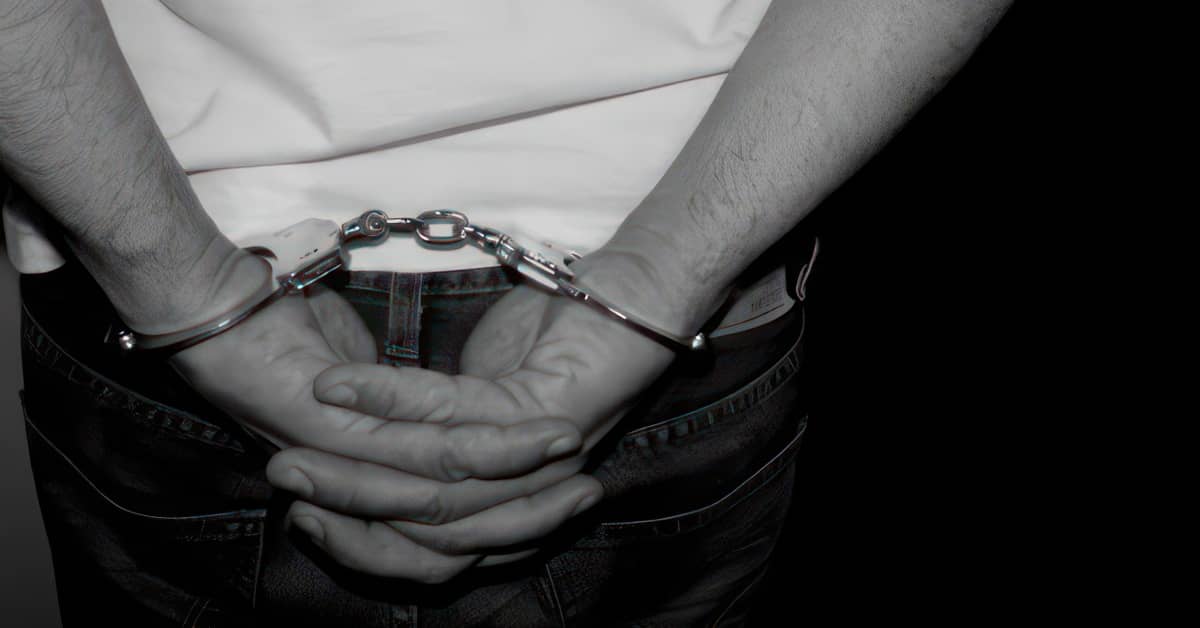Handcuffed man in black and white