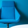 Blue office chair against a blue background
