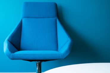 Blue office chair against a blue background