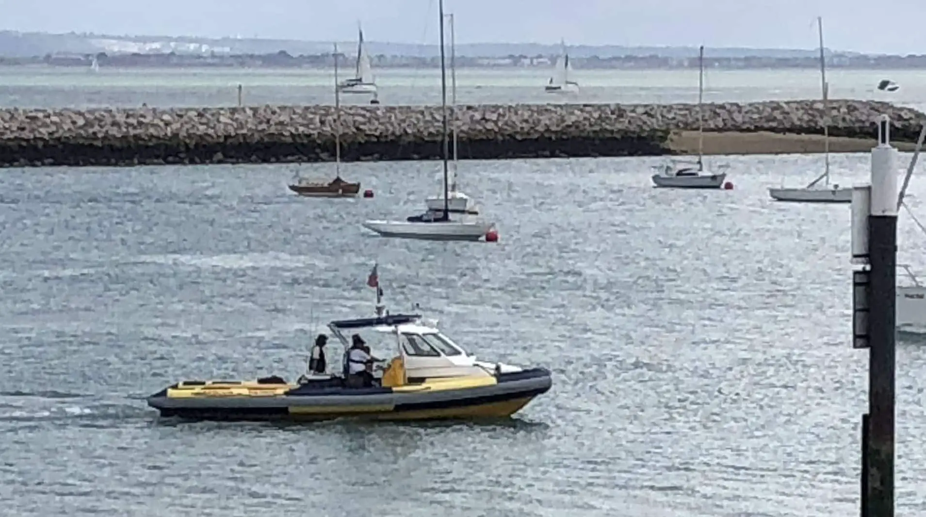 Cowes Harbour launch starts an alongside tow up-river of the fishing boat