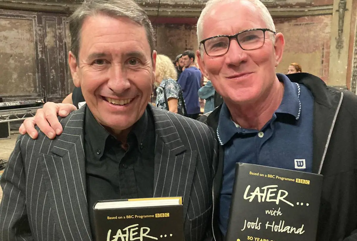 Jules Holland and Mark Cooper both holding Mark's book