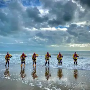 Upsized - Sandown and Shanklin Independent Lifeboat Crew lined up on the beach for Volunteers Week