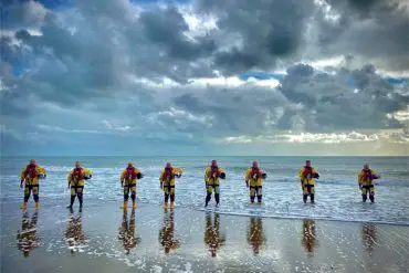 Upsized - Sandown and Shanklin Independent Lifeboat Crew lined up on the beach for Volunteers Week