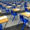 desks and chairs set up in a hall ready for exams