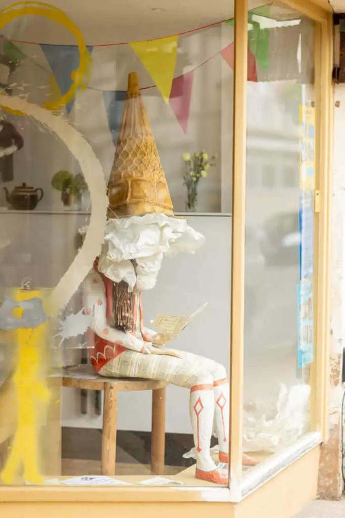Grimaldi the clown (by the late Jenny Clayden) in the window with Shilling ice cream hat