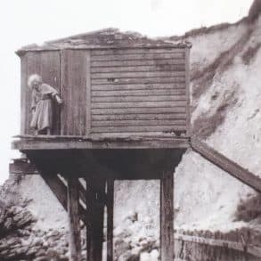 Old photo of Olivia Parkes outside her hut