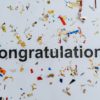Letters spelling out congratulations with streamers