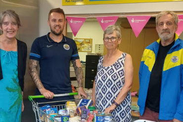Newport FC representatives delivering donations to Pan Together Pantry in Furrlongs, Newport. L-R: Pan Together Community Centre Manager Rachel Thompson, Newport FC player Joe Butcher, Pan Together Trustee Mary Craven and Newport Supporters Trust Foodbank Co-ordinator Nick Sewell