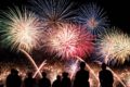 Silhouettes of people watching fireworks