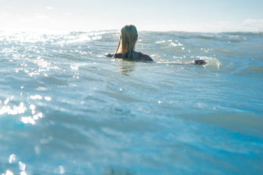 Woman in the sea with a wet suit on