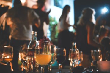 drinks on a table with people in the background