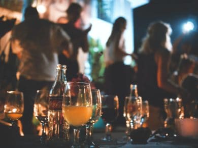 drinks on a table with people in the background