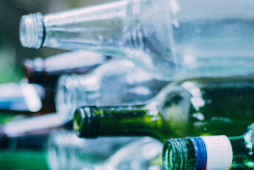 glass bottles stacked for recycling