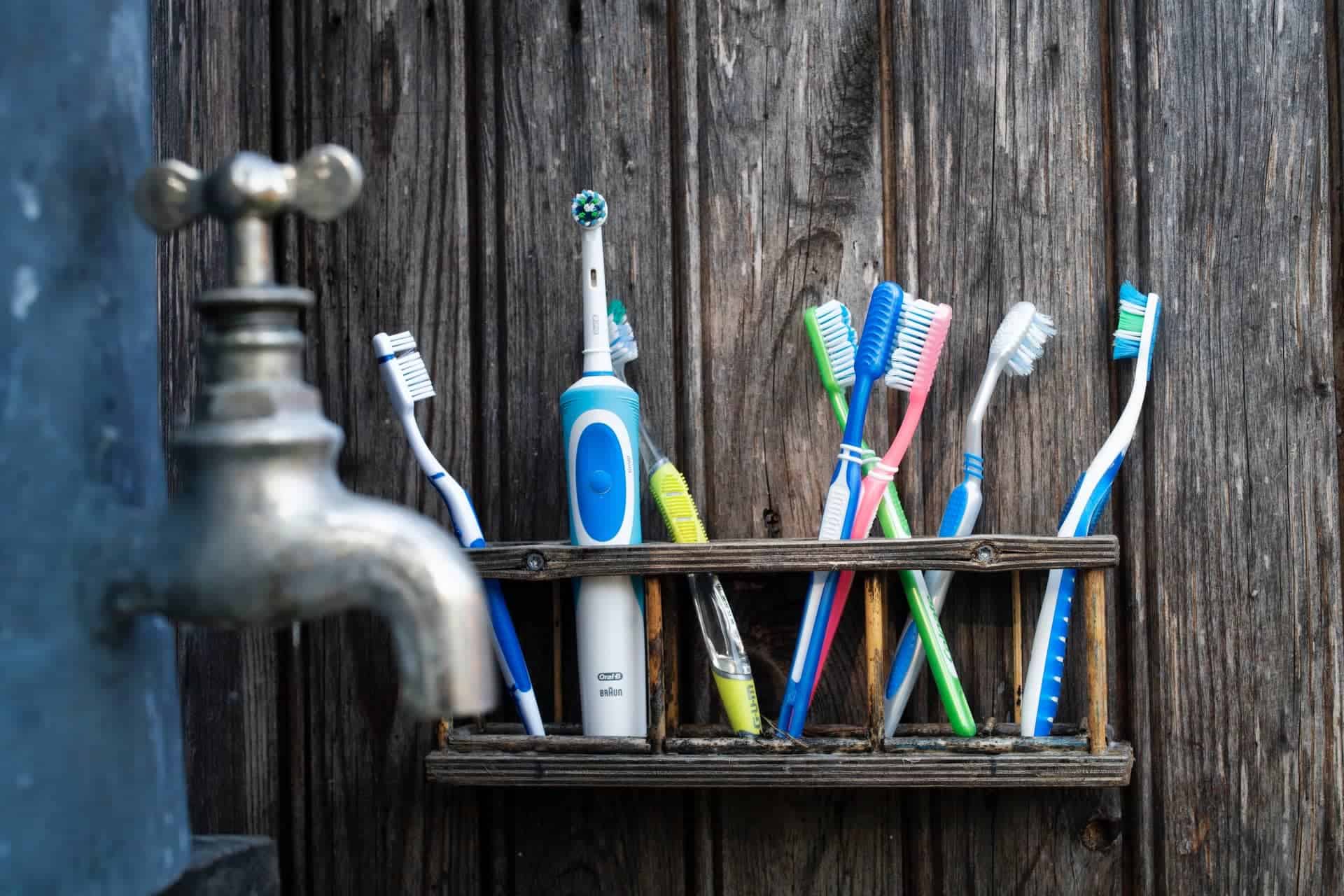 toothbrushes on shelf in bathroom