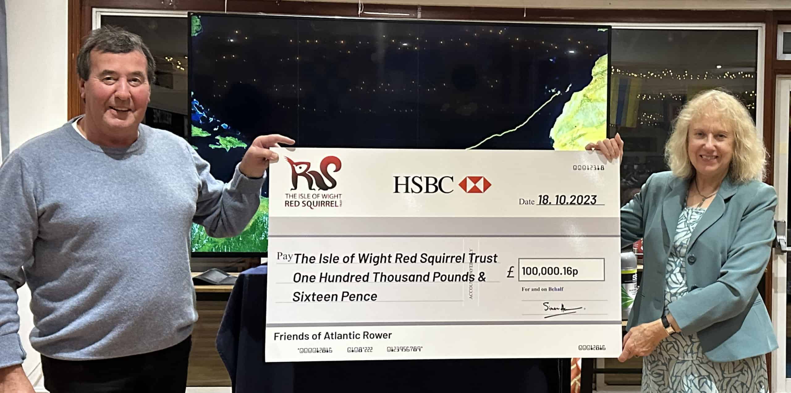 Atlantic Rower presenting a cheque for £100,000.16p to The Chair of the Isle of Wight Red Squirrel Trust