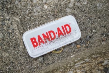 Band aid tin on the pavement