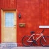 Front door of house with bicycle leaning up against the wall