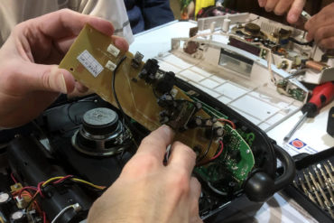 Repair Cafe volunteer mending electronics