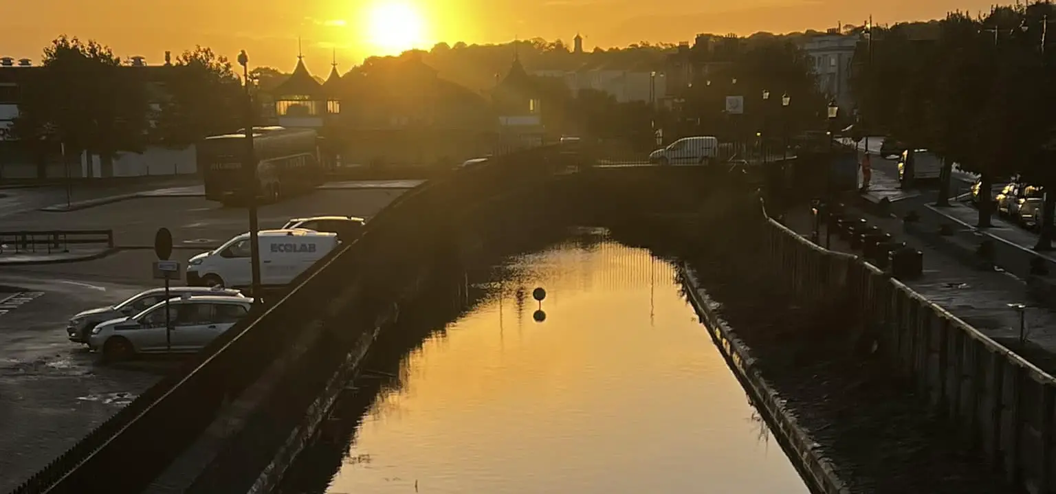 Sun rising over flooded railway track in Ryde by Lauren White